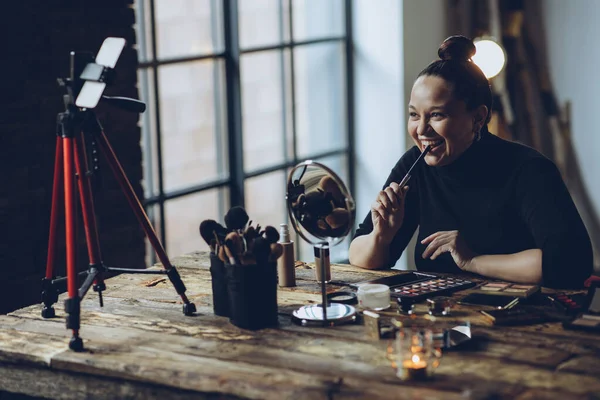 A woman does makeup live.