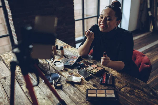 A woman does makeup live.