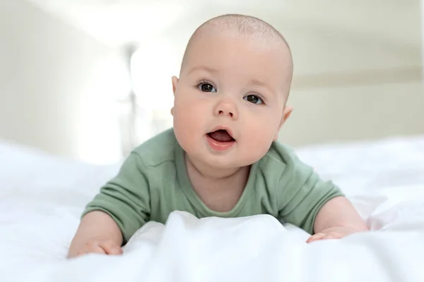 赤ん坊はベッドの上に横たわっている。小さな赤ん坊. — ストック写真