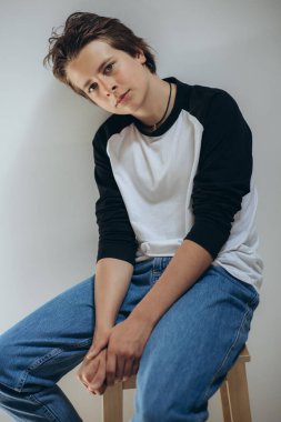 Portrait of a handsome teenage boy posing against a white background. Studio shot. Teenage fashion.