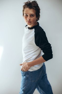 Portrait of a handsome teenage boy posing against a white background. Studio shot. Teenage fashion.