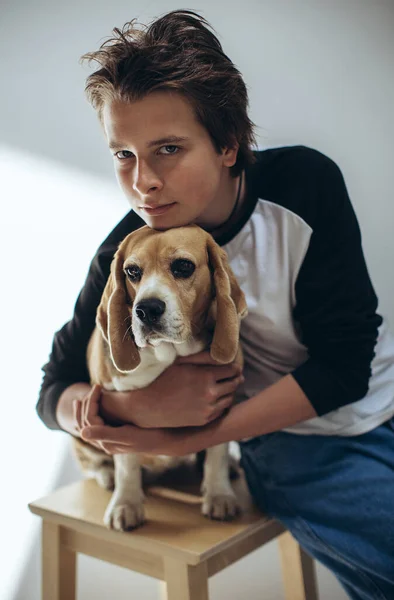 Portrait of a handsome teenage boy with a dog posing on a white background. Studio shot.Child with a dog. — 스톡 사진