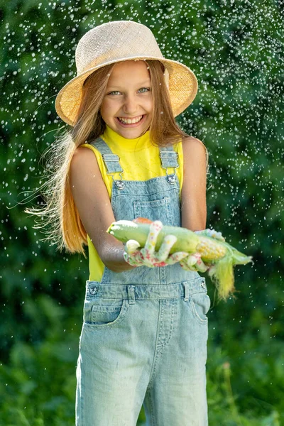 Child with vegetables. Happy little girl holding vegetables in her hands. High quality photo