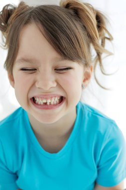 The child has lost a tooth. Little girl without a tooth. The first tooth fell out. High quality photo