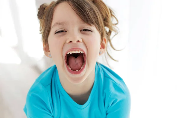 The child has lost a tooth. Little girl without a tooth. The first tooth fell out. High quality photo