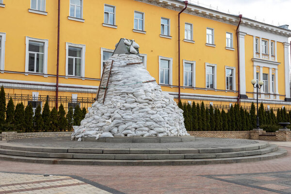 KYIV, UKRAINE April 12, 2022: War in Ukraine. Monument to Mikhail Grushevsky in snadbags, near National Univarsity of Taras Shevchenko.