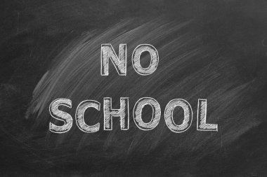 Hand drawn text NO SCHOOL on blackboard.
