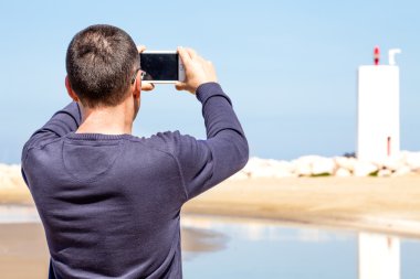 Man Photographing With Smartphone clipart