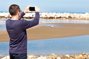 Man Taking Pictures With Smartphone clipart