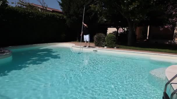 Man Cleaning Swimming Pool — Stock Video