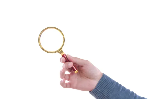 Male hand holding a magnifying glass — Stock Photo, Image