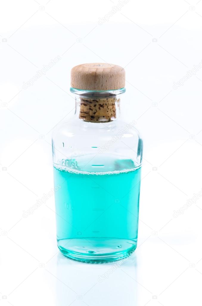 Glass bottle of turquoise blue liquid