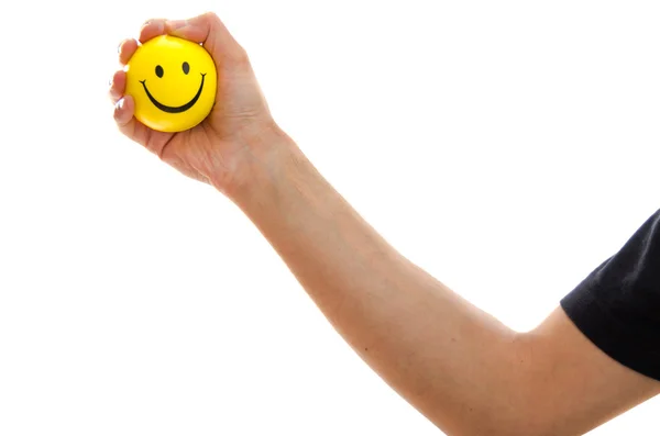 Man holding a yellow smiley emoticon — Stock Photo, Image