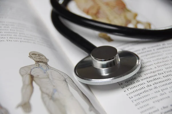 Stethoscope on a medical textbook — Stock Photo, Image