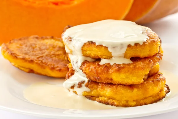 Pumpkin pancakes with sour cream — Stock Photo, Image