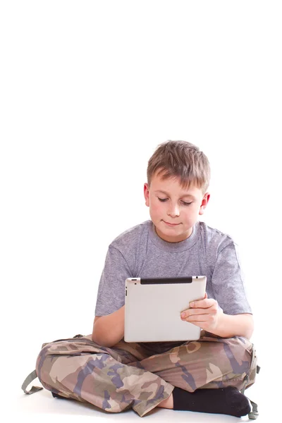 Teen plays on the tablet computer — Stock Photo, Image