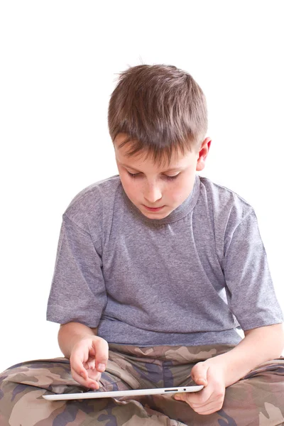 Teen plays on the tablet computer — Stock Photo, Image