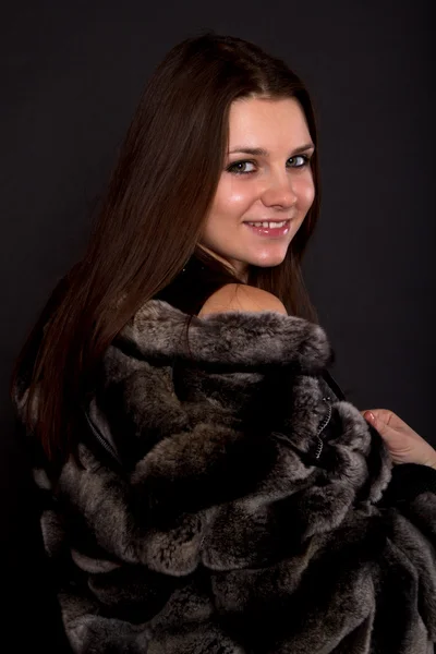 Beautiful girl in a fur coat — Stock Photo, Image