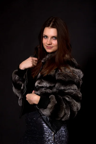 Beautiful girl in a fur coat — Stock Photo, Image