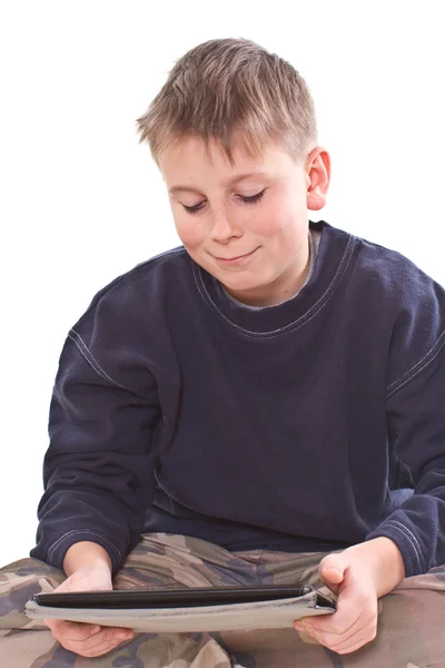 Teen plays on the tablet computer — Stock Photo, Image