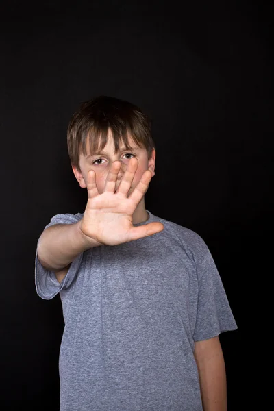 Boy shows his hand to stop — Stock Photo, Image