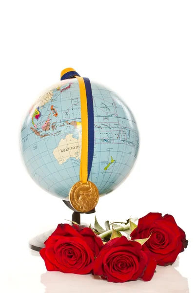 Gold medal with a globe and flowers — Stock Photo, Image