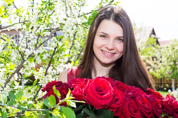 Happy girl with flowers in spring — Stock Photo, Image