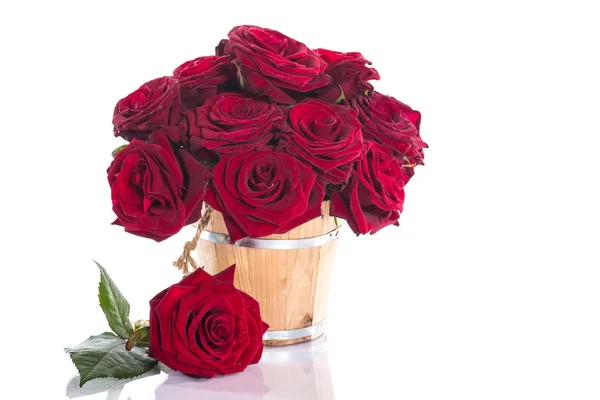 Beautiful red roses in a wooden bucket — Stock Photo, Image