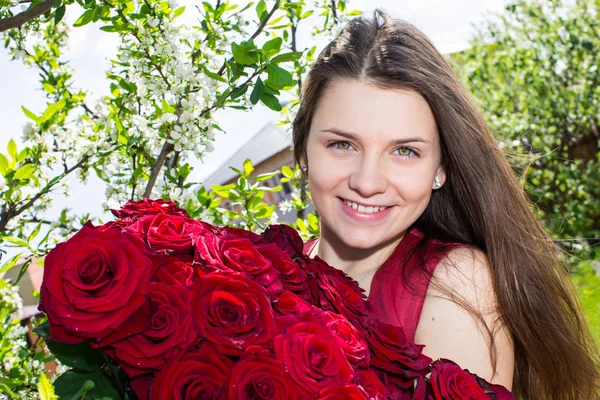 Happy girl with flowers in spring — Stock Photo, Image