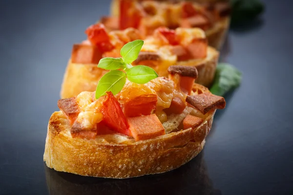 Bruschetta with cheese and tomatoes — Stock Photo, Image