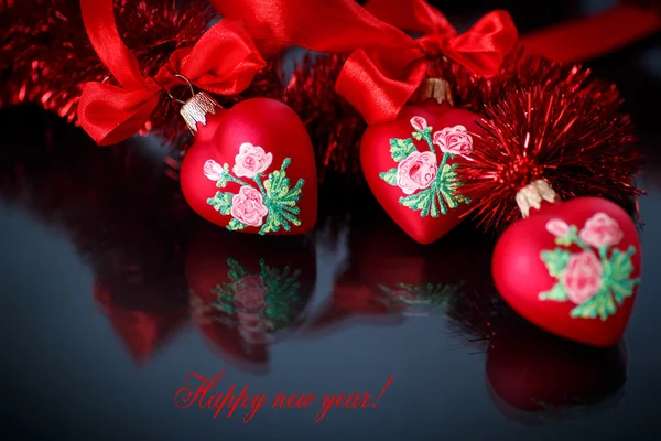 Christmas red hearts with red garland — Stock Photo, Image