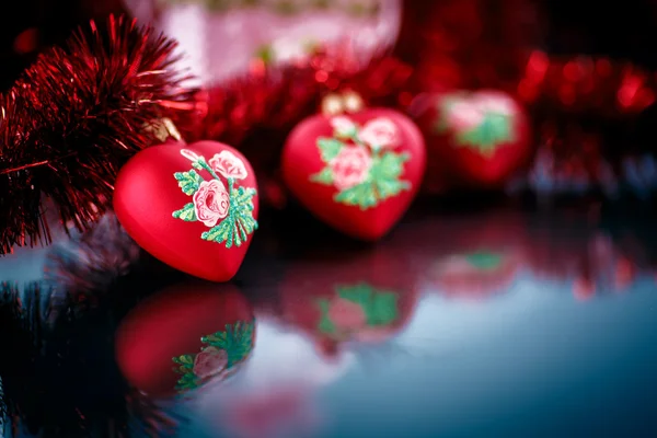 Christmas red hearts with red garland — Stock Photo, Image