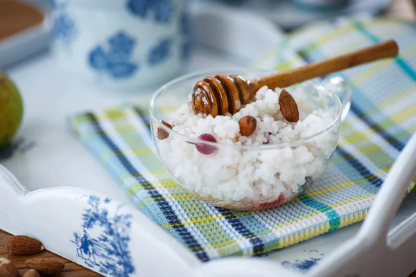 Rice porridge with nuts and honey — Stock Photo, Image