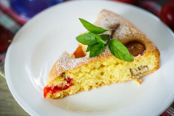Biscuit cake with cherry plums — Stock Photo, Image