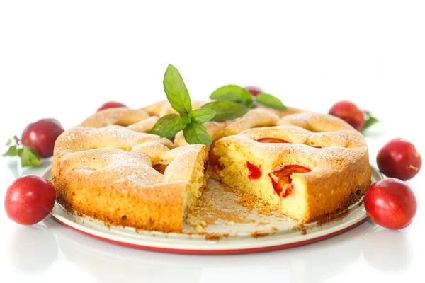 Biscuit cake with cherry plums — Stock Photo, Image