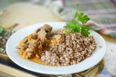 buckwheat cooked with stewed chicken gizzards clipart