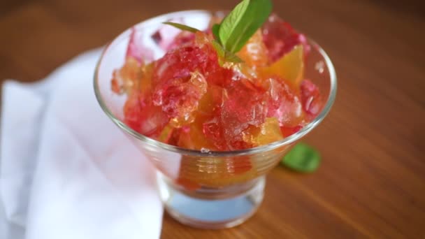 Colored sweet fruit jelly in a glass glass — Stock Video