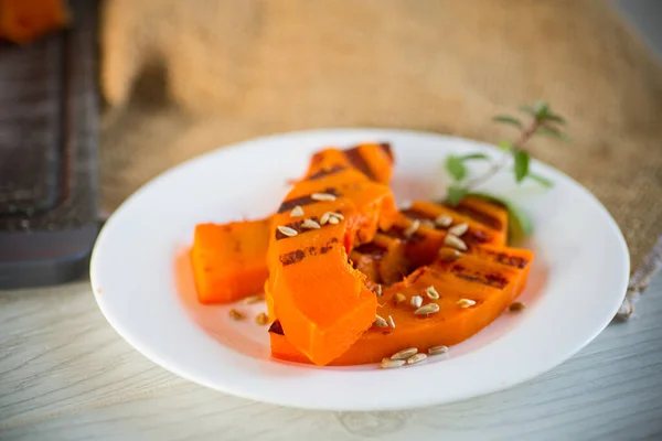 Sladká pečená grilovaná dýně se semínky na talíři — Stock fotografie
