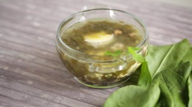 Spring soup from fresh sorrel with boiled eggs in a plate