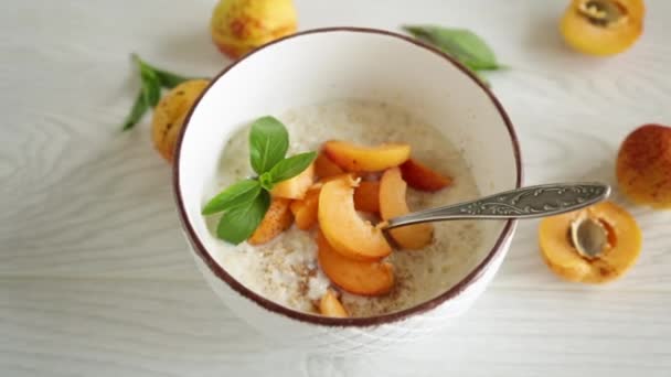 Healthy Breakfast Boiled Oatmeal Fresh Apricots Bowl Table — Stockvideo