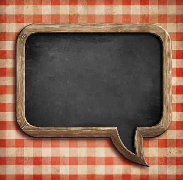 Menu chalkboard on table in shape of speech bubble — Stock Image Menu chalkboard on table in shape of speech bubble Royalty Free Stock Images