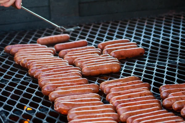 Turning Hot Dogs On The Grill — Stock Photo, Image
