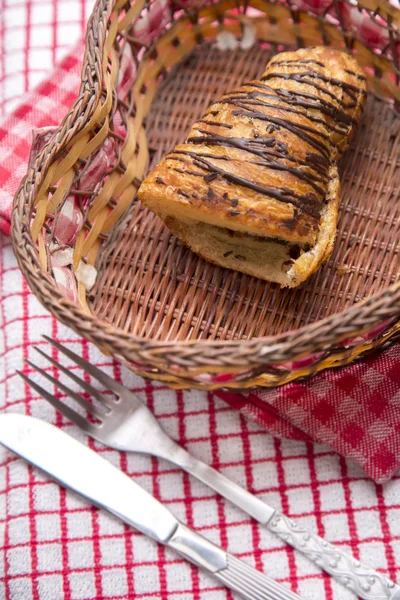 Chocolate croissants in a basket — Stock Photo, Image