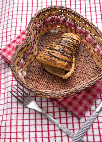 Chocolate croissants in a basket — Stock Photo, Image