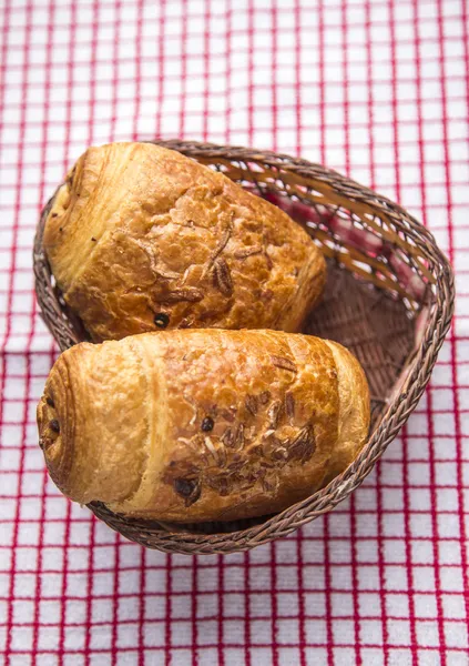 Chocolate croissants in a basket — Stock Photo, Image