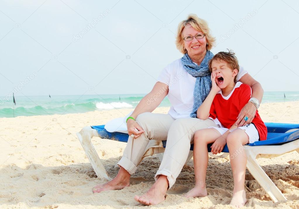 Happy grandma and grandson on vacation at sea