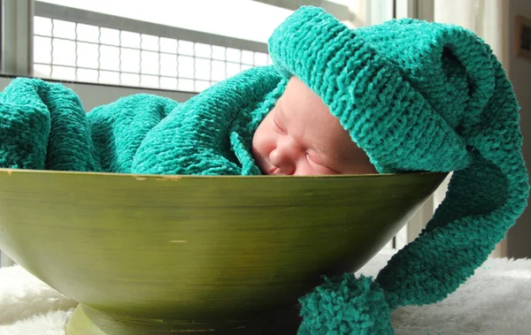 Newborn in a knitted cocoon and hat — Stock Photo, Image