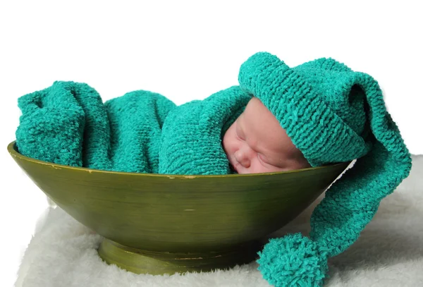 Newborn in a knitted cocoon and hat — Stock Photo, Image