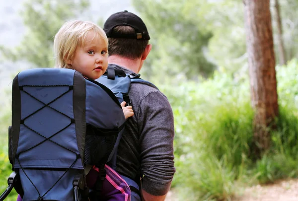 Батько гуляє з дитиною на рюкзаку — стокове фото