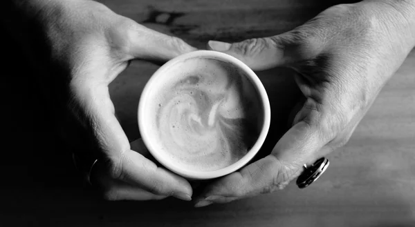 Senior woman holding hot cup of coffee — Stock Photo, Image